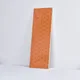 A close-up of a Subway Wall Tile TL 06427 V Eterna Tangerine Orange 12 x 4 inch Ceramic Glossy Finish - 8 mm | 24 Random Design | Suitable for Accent / Feature Walls, Bathroom, Kitchen Wall & Backsplashes with a Glossy finish available at Material Depot in Bangalore