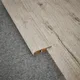 A close-up of a MDF Reducer R Profile Aristo Premium PM 00369 K | 8 ft x 23 mm x 12 mm | Compatible for Laminate Wood Floor LF 00246 available at Material Depot in Bangalore