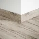 A close-up of a MDF Skirting Aristo Premium PM 00370 G | 8 ft x 4 Inch | Compatible for Laminate Wood Floor LF 00248 available at Material Depot in Bangalore