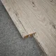 A close-up of a MDF Reducer R Profile Aristo Premium PM 00370 L | 8 ft x 25 mm x 12 mm | Compatible for Laminate Wood Floor LF 00248 available at Material Depot in Bangalore