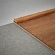 A close-up of a MDF Corner Beading Profile Aristo Premium PM 00371 B | 8 ft x 18 mm x 12 mm | Compatible for Laminate Wood Floor LF 00251 available at Material Depot in Bangalore