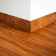A close-up of a MDF Skirting Aristo Premium TF 00371 Y | 8 ft x 115 mm | Compatible for Laminate Wood Floor LF 00251 available at Material Depot in Bangalore