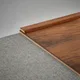 A close-up of a MDF Corner Beading Profile Aristo Premium PM 00366 B | 8 ft x 18 mm x 12 mm | Compatible for Laminate Wood Floor LF 00252 available at Material Depot in Bangalore