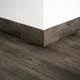 A close-up of a MDF Skirting Aristo Premium PM 00372 F | 8 ft x 3.5 Inch | Compatible for Laminate Wood Floor LF 00253 available at Material Depot in Bangalore