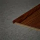 A close-up of a MDF L Nosing Profile Aristo PM 00359 X | 8 ft x 25 x 45 x 12 mm | Compatible for Laminate Wood Floor LF 00259 available at Material Depot in Bangalore