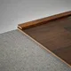 A close-up of a MDF Corner Beading Profile Gleam PM 00385 | 8 ft x 12 mm x 12 mm | Compatible for Laminate Wood Floor LF 00261 available at Material Depot in Bangalore