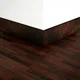 A close-up of a MDF Skirting Gleam PM 00386 E | 8 ft x 3 Inch | Compatible for Laminate Wood Floor LF 00263 available at Material Depot in Bangalore