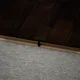 A close-up of a MDF T Profile Gleam PM 00387 M | 8 ft x 12 mm x 12 mm | Compatible for Laminate Wood Floor LF 00264 available at Material Depot in Bangalore
