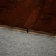 A close-up of a MDF T Profile Heirloom PM 00350 P | 8 ft x 23 mm x 12 mm | Compatible for Laminate Wood Floor LF 00269 available at Material Depot in Bangalore