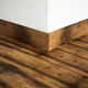 A close-up of a MDF Skirting Edge Flow PM 00382 E | 8 ft x 3 Inch | Compatible for Laminate Wood Floor LF 00273 available at Material Depot in Bangalore