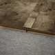 A close-up of a MDF T Profile Timberlux PM 00373 P | 8 ft x 23 mm x 12 mm | Compatible for Laminate Wood Floor LF 00277 available at Material Depot in Bangalore