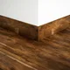 A close-up of a MDF Skirting Timberlux PM 00375 G | 8 ft x 4 Inch | Compatible for Laminate Wood Floor LF 00279 available at Material Depot in Bangalore
