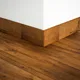 A close-up of a MDF Skirting Aqua Lock PM 00400 D | 8 ft x 2.5 Inch | Compatible for Laminate Wood Floor LF 00283 available at Material Depot in Bangalore