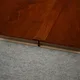 A close-up of a MDF T Profile Aqua Lock PM 00403 P | 8 ft x 23 mm x 12 mm | Compatible for Laminate Wood Floor LF 00286 available at Material Depot in Bangalore