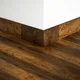 A close-up of a MDF Skirting Aqua Lock PM 00406 D | 8 ft x 2.5 Inch | Compatible for Laminate Wood Floor LF 00289 available at Material Depot in Bangalore