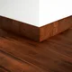 A close-up of a MDF Skirting Aqua Lock PM 00407 G | 8 ft x 4 Inch | Compatible for Laminate Wood Floor LF 00290 available at Material Depot in Bangalore