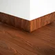 A close-up of a WPC Skirting Stone Core TF 00011 G | 8 ft x 3.5 Inch x 12 mm | Compatible for SPC Floor SP 00074 available at Material Depot in Bangalore