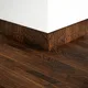 A close-up of a MDF Skirting Herringbone PM 00396 E | 8 ft x 3 Inch | Compatible for Laminate Wood Floor LF 00297 available at Material Depot in Bangalore