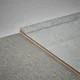 A close-up of a WPC Corner Beading Profile Stone Core TF 00011 | 8 ft x 12 mm x 12 mm | Compatible for SPC Floor SP 00074 available at Material Depot in Bangalore
