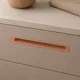 HA 00190 O Ottr Concealed Handle Bronze Finish 16in â close-up of copper handle on beige drawer