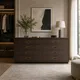 HA 00198 E Ottr Concealed Handle Black Pvd Gold Finish 36in â gold-framed handles on dark wood chest of drawers