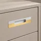 HA 00200 S Ottr Concealed Handle Pvd Gold White Finish 24in â close-up of white and gold handle on taupe drawer