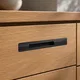 HA 00200 Ottr Concealed Handle Black Dual Tone Finish 8in â close-up of black handle on oak drawer