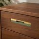 HA 00200 N Ottr Concealed Handle Pvd Gold Green Finish 24in â close-up of gold and green handle on walnut drawer