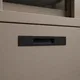 HA 00203 Ottr Concealed Handle Black Gold Finish 8in â close-up of black handle on taupe cabinet