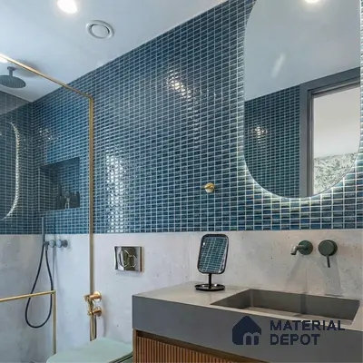 Modern bathroom walkthrough with blue mosaic wall tiles, concrete countertop, and fluted wood vanity
