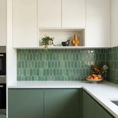 Modern kitchen walkthrough with sage green laminate cabinets, white laminate overheads, and scallop green backsplash tile