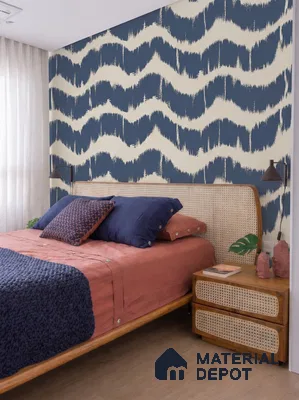 Mid-century modern bedroom with blue geometric wallpaper and cane wood bed