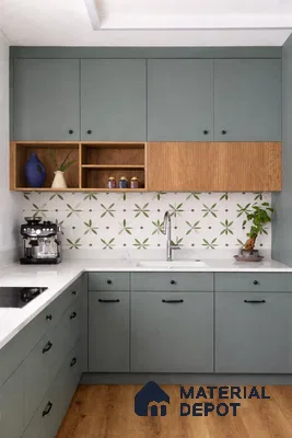 Scandinavian kitchen with sage green laminate cabinets, oak wood laminate, and floral patterned backsplash tiles