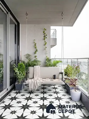 Modern balcony with black and white geometric patterned floor tiles and glass railing