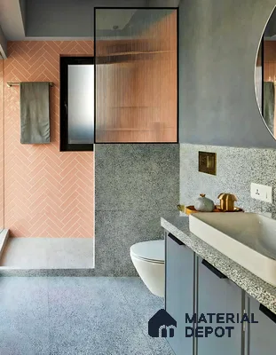 Modern bathroom with peach herringbone wall tiles and terrazzo floor and countertop of 4 BHK apartment in Aparna Elina Yeshwanthpur in Bengaluru