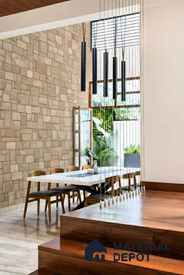 Modern dining room with beige stone cladding wall, white dining table, and walnut wood flooring of 4 BHK apartment in Aparna Elina Yeshwanthpur in Bengaluru