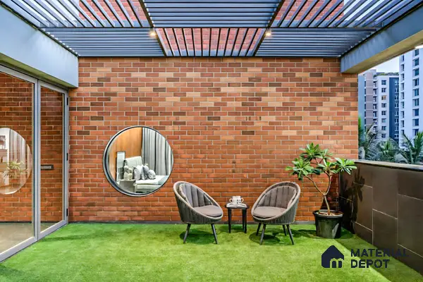 Modern balcony with exposed brick cladding, artificial grass flooring, and metal pergola ceiling of 4 BHK apartment in Aparna Elina Yeshwanthpur in Bengaluru
