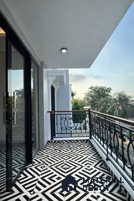 Modern balcony with black-and-white geometric patterned floor tiles and wrought iron railing