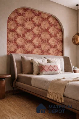Bohemian bedroom with patterned wallpaper accent, textured beige wall, and wooden flooring
