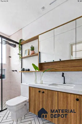 Scandinavian bathroom with wood laminate vanity, white quartz countertop, and herringbone patterned floor tiles