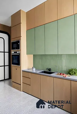 Scandinavian kitchen with sage green laminate, light wood laminate, and geometric patterned floor tile