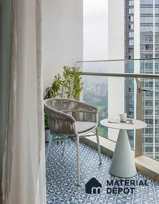 Modern balcony with blue and white geometric patterned floor tiles and minimalist outdoor furniture