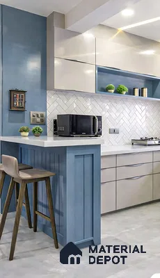Modern kitchen with blue and frosty white laminate, white quartz countertop, and herringbone subway backsplash tile