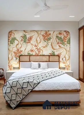 Scandinavian bedroom with floral wallpaper accent, cane headboard, and light wood flooring