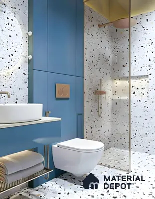 Modern bathroom with blue vanity, terrazzo wall and floor tiles, and gold fixtures in Ashoka Windows and Annexe Kaggadasapura 3 BHK apartment Bengaluru
