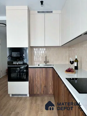 Modern kitchen with walnut wood laminate, frosty white laminate, white quartz countertop, and beige geometric backsplash tile