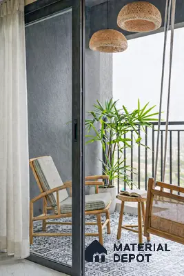Scandinavian balcony with patterned black-and-white floor tiles and natural cane furniture