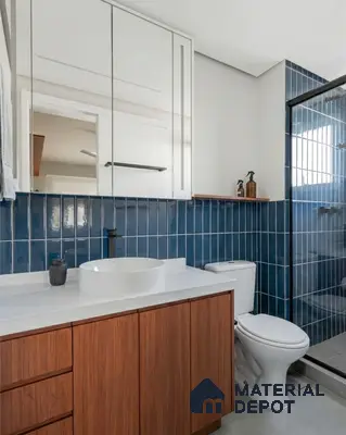 Modern bathroom with blue vertical subway wall tiles, white countertop, and walnut wood vanity