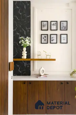 Modern foyer with walnut wood laminate cabinets, black marble-look accent panel, and white countertop