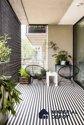Modern balcony with black-and-white striped geometric floor tiles and minimalist metal furniture